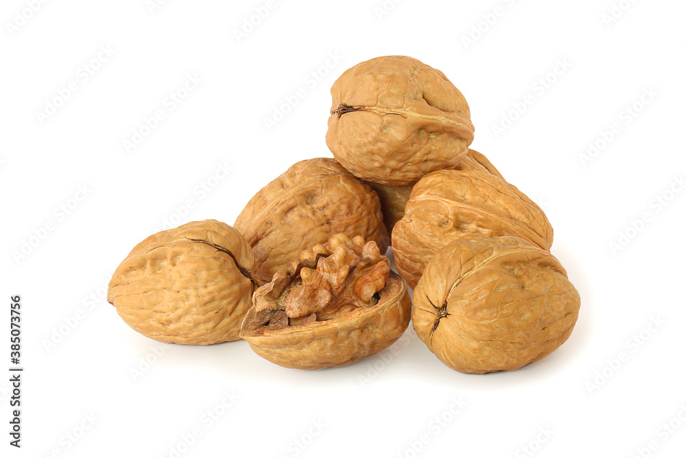 Several whole walnuts and uncovered walnut isolated on the white Several whole walnuts and uncovered walnut isolated on the white
