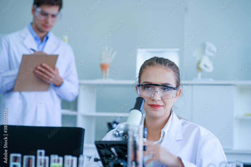 Attractive Caucasian european medical scientist working with microscope in laboratory . Health care and medicine. concept. virus pandemic concept. Attractive Caucasian european medical scientist working with microscope in laboratory . Health care and medicine. concept. virus pandemic concept.