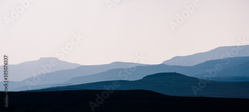 Isle of Skye - misty island landscape - hills silhouette covered in mist