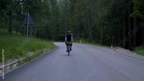 Wallpaper Mural Cyclist with red helmet cycling through a forest on early morning with model release, Dolomites Italy Torontodigital.ca