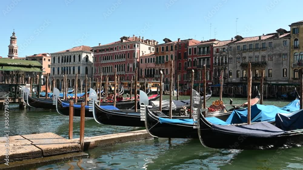 Venice, Italy - gondolas and gondoliers in the Grand Canal near the Rialto Bridge and between the canals of the lagoon city Venice, Italy - gondolas and gondoliers in the Grand Canal near the Rialto Bridge and between the canals of the lagoon city