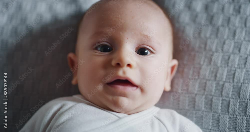 Authentic close up shot of a cute newborn baby is smiling in the camera. Authentic close up shot of a cute newborn baby is smiling in the camera.