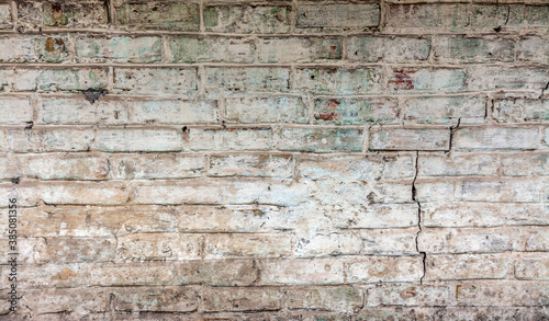 Old brickwork with crumbling plaster. Building wall. Graphic resources. Background. Vintage. Retro.