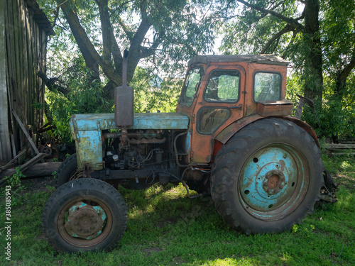 26.07.2020 Russia, Bryansk region. An old rusty dirty tractor is parked in the yard. Non-working rural equipment