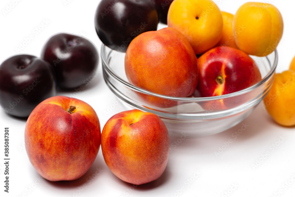 nectarine, peach and plum on a white background