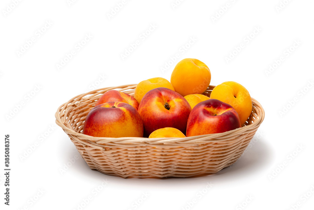 nectarine, peach and plums in a wicker basket on a white background nectarine, peach and plums in a wicker basket on a white background