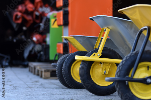 row of new garden wheelbarrows in hardware store