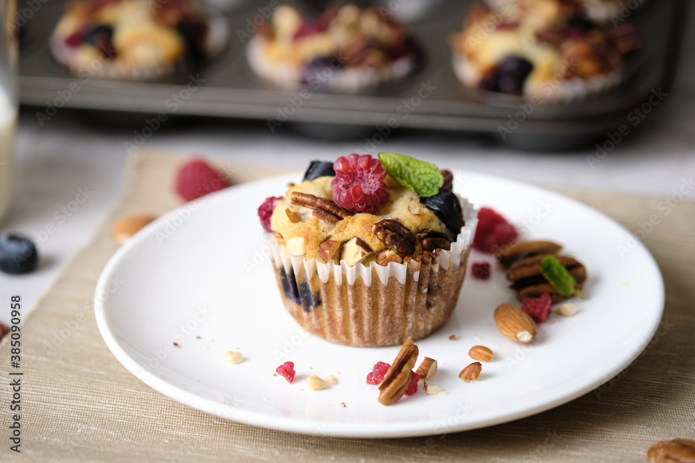 mixed berry low carb Keto Diet muffin with almond and nut. set on cafe table. mixed berry low carb Keto Diet muffin with almond and nut. set on cafe table.