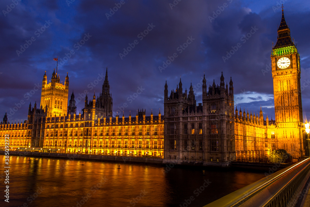 The Parliament, the Big Ben and the Westminster bridge at night, London, England