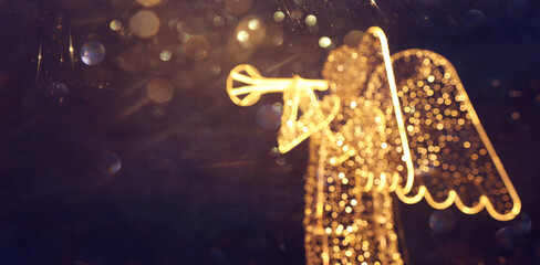 Abstract and bokeh background of luminous angel figure with christmas lights