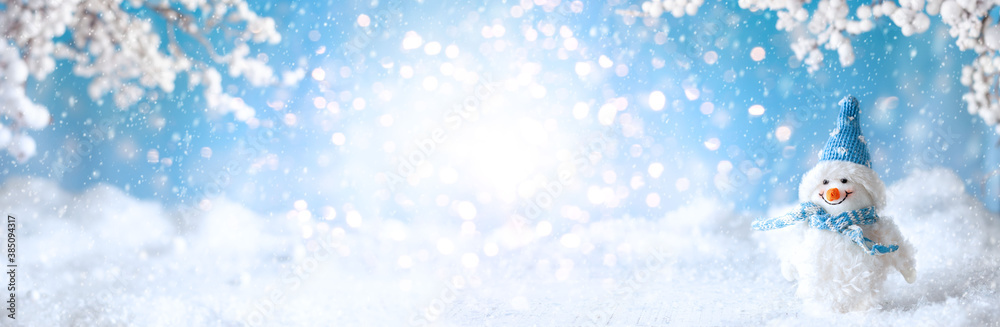 Funny Snowman on winter snowy background with snowy branches. Christmas or Winter concept.