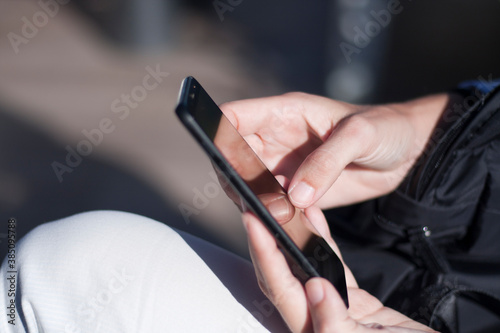 young girl hands with mobile phone