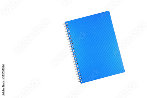 Blue notebook for notes on a spiral with a plastic cover close-up. Top view with copy space. Isolated on white background. Blank for design.