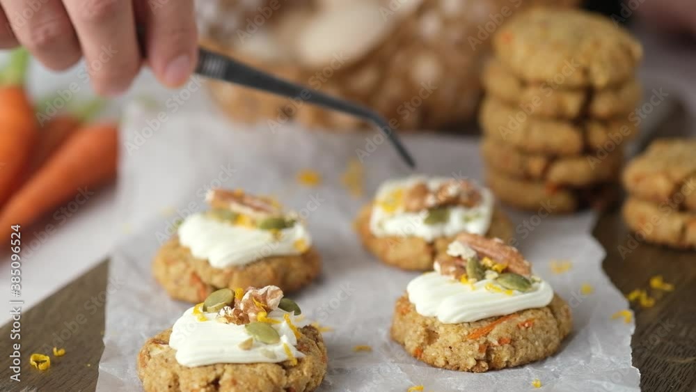 Pastry chef making Keto Carrot oatmeal cookies for Healthy homemade ketogenic diet with white cream, nut and seeds. Pastry chef making Keto Carrot oatmeal cookies for Healthy homemade ketogenic diet with white cream, nut and seeds.