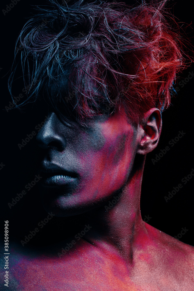 Beauty style portrait of guy isolated at dark background. Art colors Makeup. Hairstyle and skincare concept. Beauty style portrait of guy isolated at dark background. Art colors Makeup. Hairstyle and skincare concept.