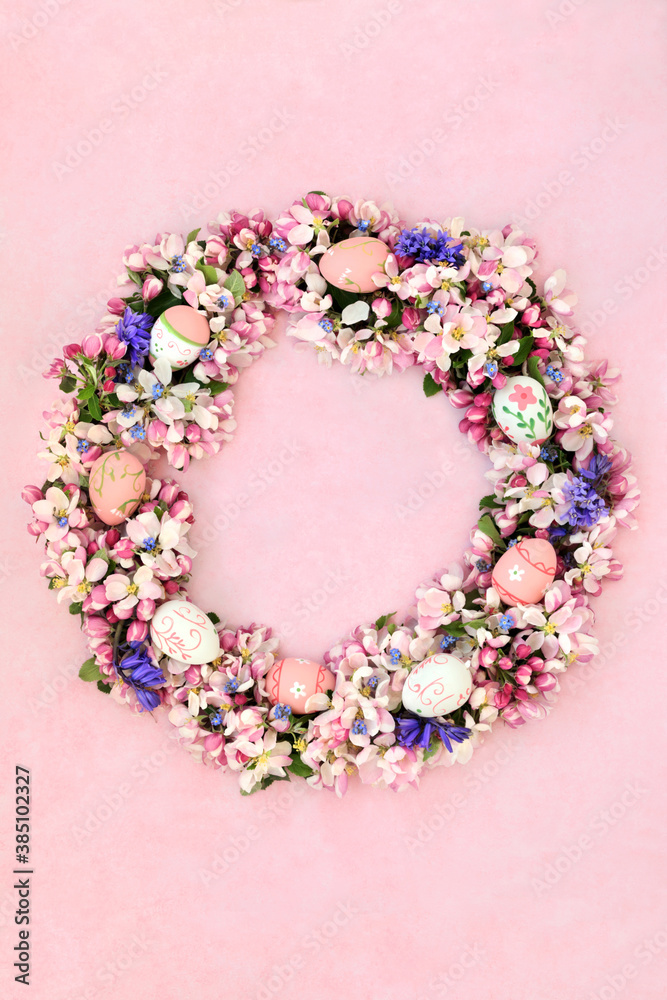 Easter eggs & apple blossom, bluebell &forget me not flower wreath on mottled pink. Greetings card, invitation or design element for Easter.  Flat lay.