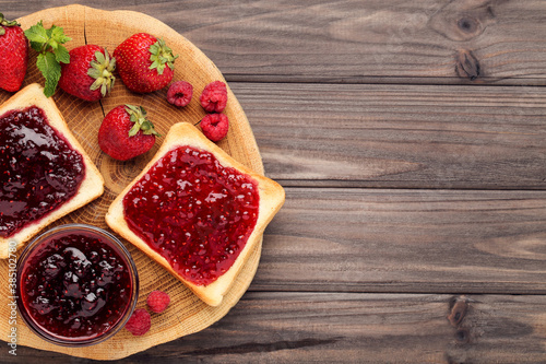 Wallpaper Mural Toasts with jam and ripe berries on wooden table Torontodigital.ca