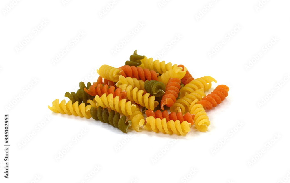 Multicolored Buckwheat spiral dry pasta isolated on white. Ancooked pasta noodles isolated on white background. Multicolored Buckwheat spiral dry pasta isolated on white. Ancooked pasta noodles isolated on white background.