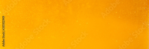 Texture of natural golden honey, food background.