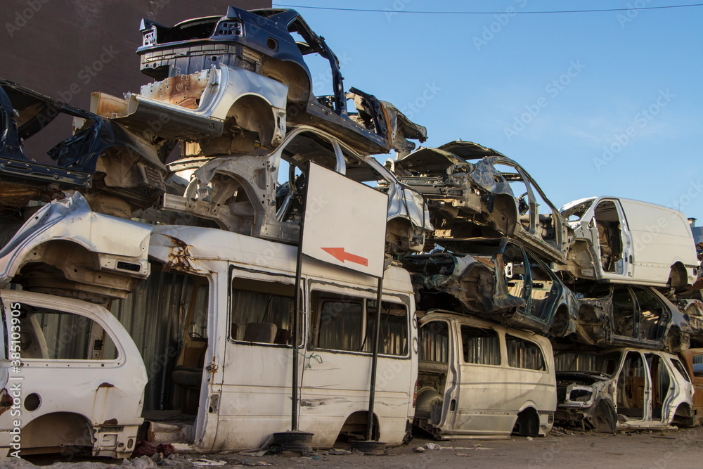 cars waiting to be recycle in junk yard in Turkey, Ankara - stacked cars in car cemetery - auto graveyard