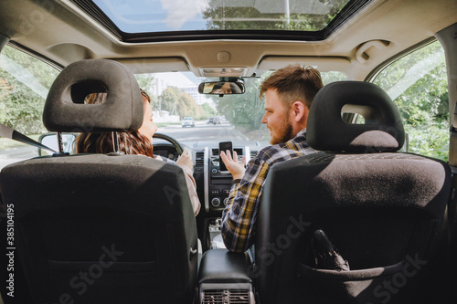 couple sitting in car driving to travel destination