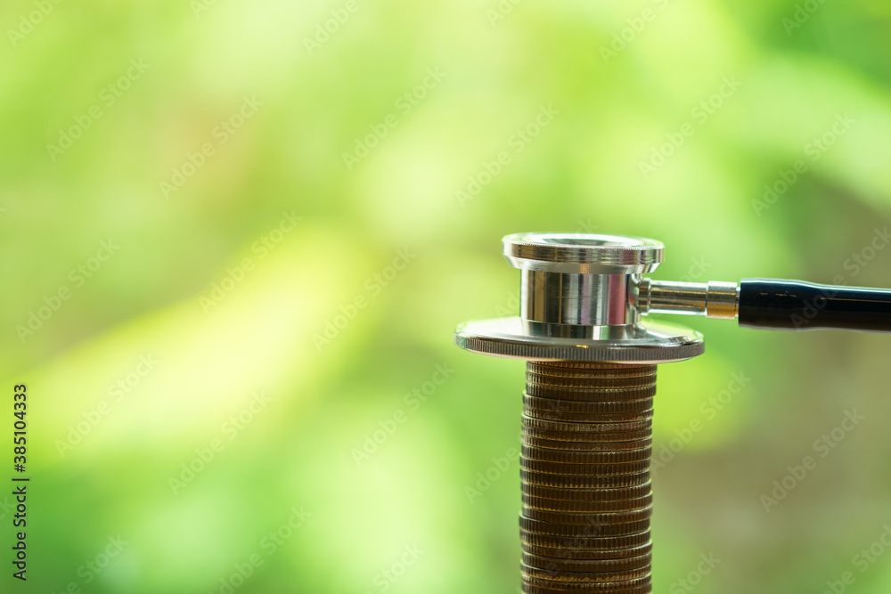 Obraz premium Money, Financial and Business Concept. Close up of stethoscope on top of stack of coins with copy space.