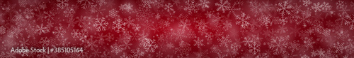 Christmas banner of snowflakes of different shapes, sizes and transparency on red background