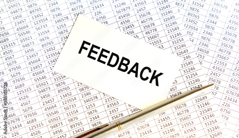 Finance and business concept. Business card with the text FEEDBACK, next to reports. Finance and business concept. Business card with the text FEEDBACK, next to reports.