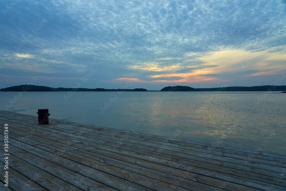 A wooden mole with mooring bollards on a sunset. Copy space. A wooden mole with mooring bollards on a sunset. Copy space.