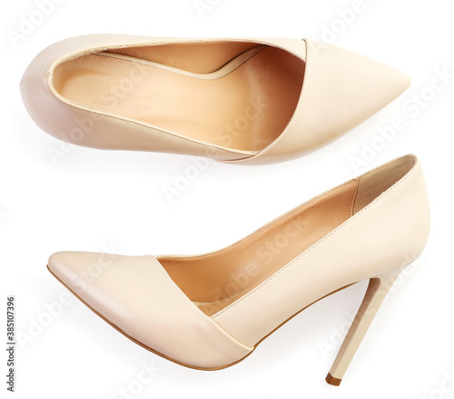 Pair of women's beige shoes on a white background, isolated. Top view