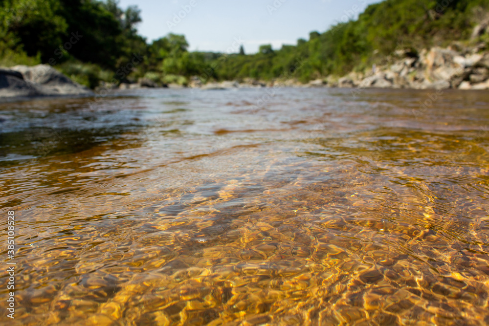 Cristaline gold water in river Icho Cruz, Carlos Paz, Argentina
