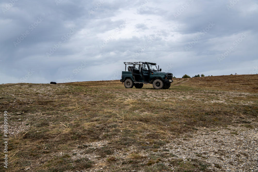mountain car on the top of the mountain against the backdrop of a mountain landscape mountain car on the top of the mountain against the backdrop of a mountain landscape