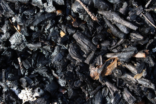 Burnt out bonfire campfire. Bombard or barbecue fire ashes close up. Burn wood ash, abstract fireplace without flame