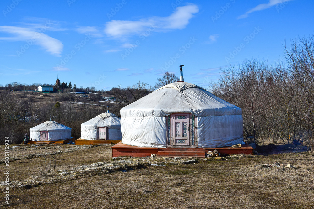Three Mongolian yurts in spring in a nature Park
