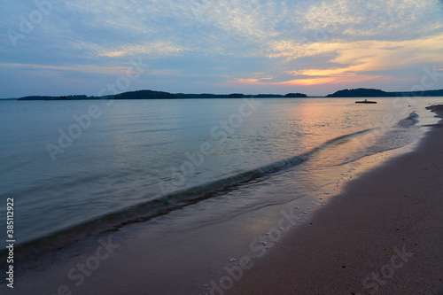 Wallpaper Mural Sunset on a sandy beach with reflection of sky on water surface and waves hitting sand. Torontodigital.ca