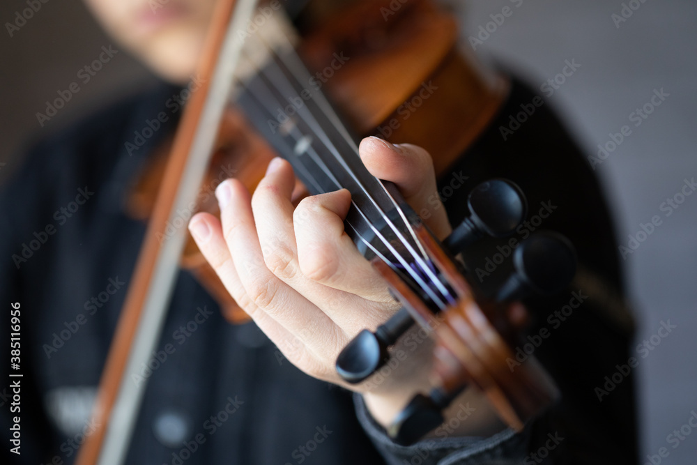 Close up of person playing the violin Close up of person playing the violin