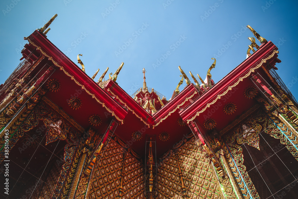 Beautiful traditional Thai Buddhist building's roof. Bottom view of art on Thai temple roof church.