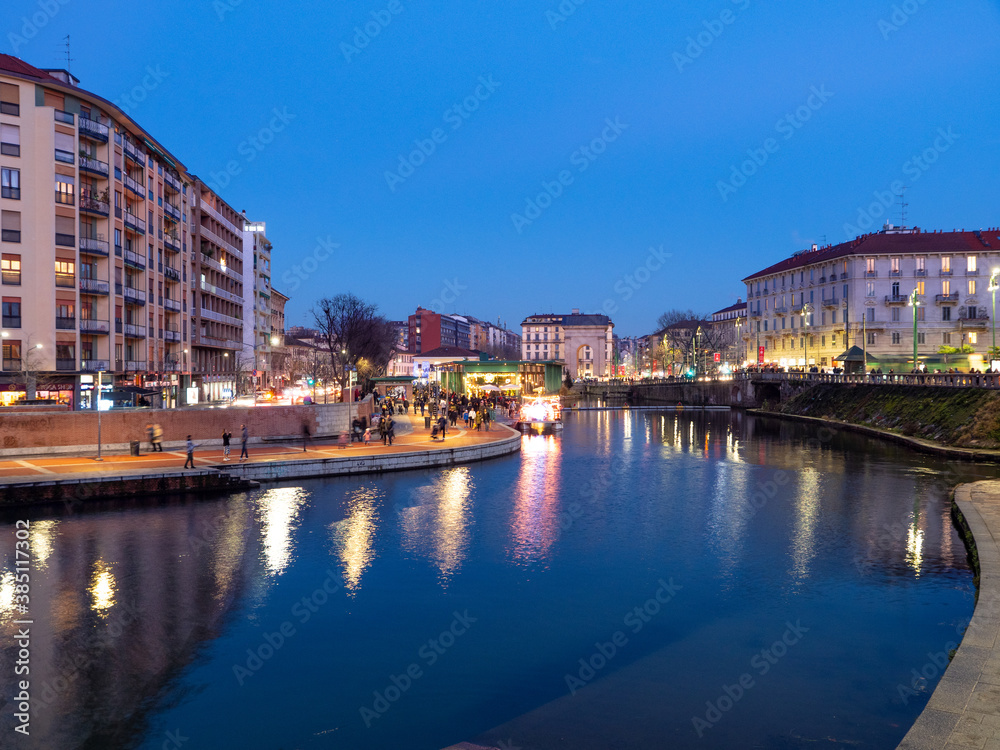 Beautiful view of Darsena in the touristic district of Milan during the blue hour and the lights of the city can be seen reflected on the water.Lombardy, Italy