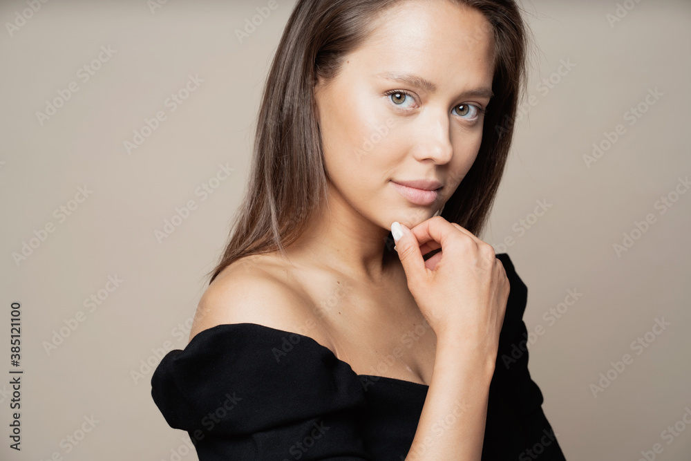portrait of a woman of European appearance, brunette with long hair, looking at the camera and smiling. Studio photography for advertising cosmetics or jewelry portrait of a woman of European appearance, brunette with long hair, looking at the camera and smiling. Studio photography for advertising cosmetics or jewelry