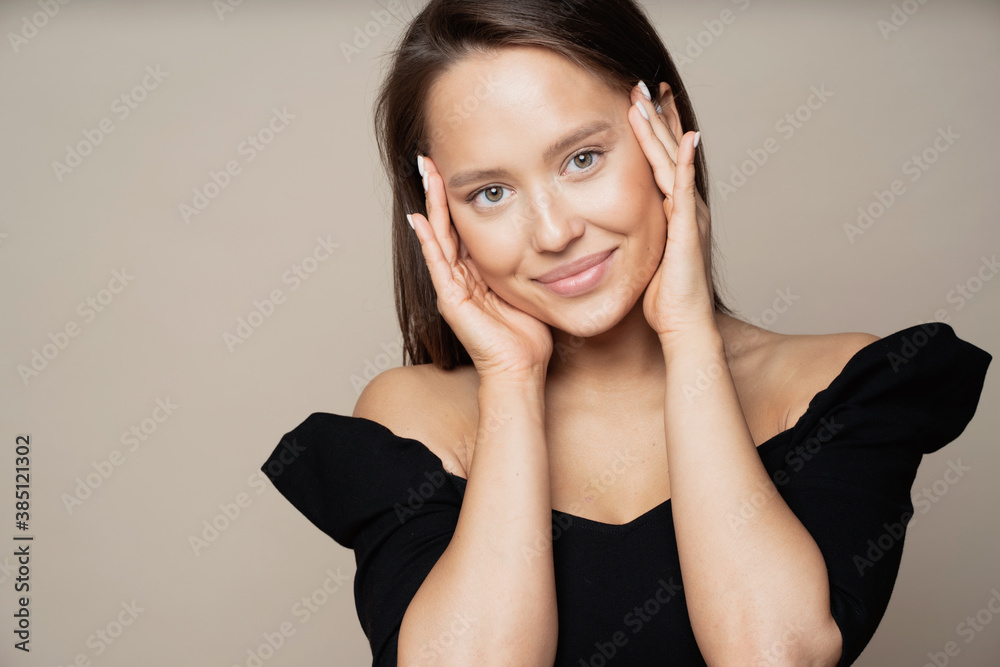positive satisfied young woman of European appearance brunette stands looking smiling and posing for the camera. black stylish clothes and good mood. positive satisfied young woman of European appearance brunette stands looking smiling and posing for the camera. black stylish clothes and good mood.