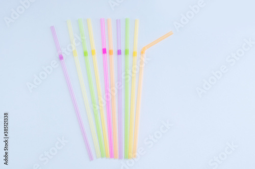 Plastic multicolored cocktail tubes in lying on white background.