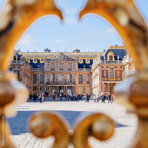 Versailles chateau. France. View of golden gate to palace. Royal residence near Paris. King's quarters. Famous touristic renaissance architecture landmark in summe photo