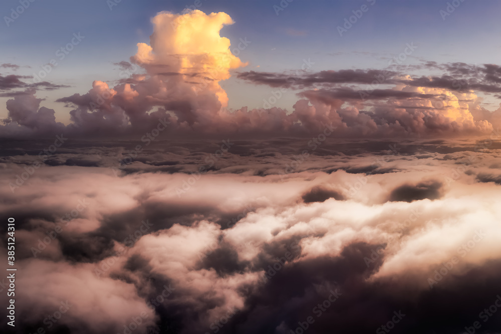 Dramatic Aerial Panoramic View of Cloudscape during a colorful sunset or sunrise. Artistic Render. Heavenly Sunlight. Nature Background