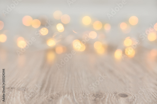 Christmas Lights Background. Copy Space. Christmas garland bokeh lights on the wooden floor