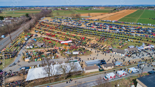 Aerial View of an Amish Mud Sale with Lots of Buggies and Farm Equipment on a Winter Day