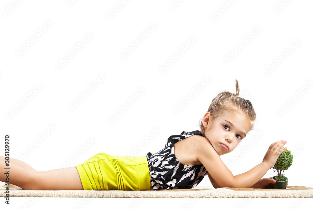 cute litthe girl lying on the ground and playing with tiny little toy ...