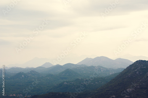 Mountain range with visible silhouettes through the morning colorful fog