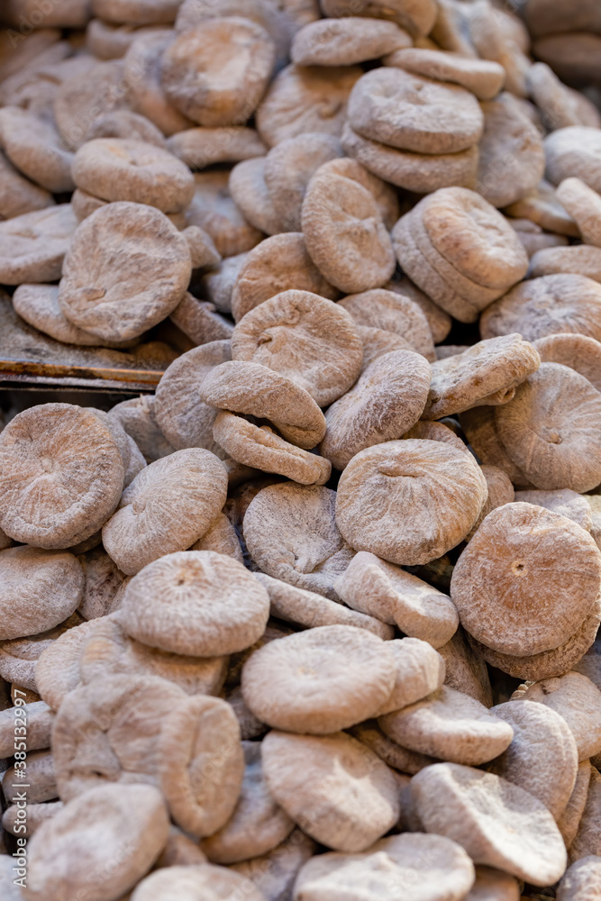 Pile of dried figs, coated in wheat flour, on a market stall Pile of dried figs, coated in wheat flour, on a market stall