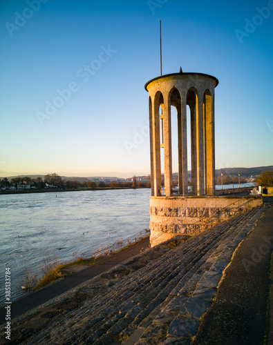 Gauge tower of Neuwied, Germany at the river Rhine with blue sky in the evening sun - copy space photo