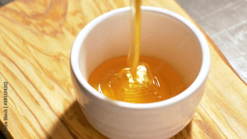 Honey Drip Pouring in white ceramic bowl Honey Drip Pouring in white ceramic bowl